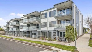 A modern multi-story residential building with balconies, a flat roof, and a clear sky. - Bay Vue - Absolute Oceanviews! (Apollo Bay)