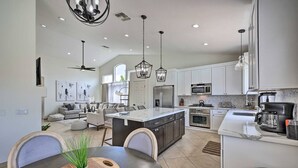 A modern kitchen with a central island, stainless steel appliances, and pendant lighting. - Hello Sunshine! Private Heated Pool Included! (Scottsdale)