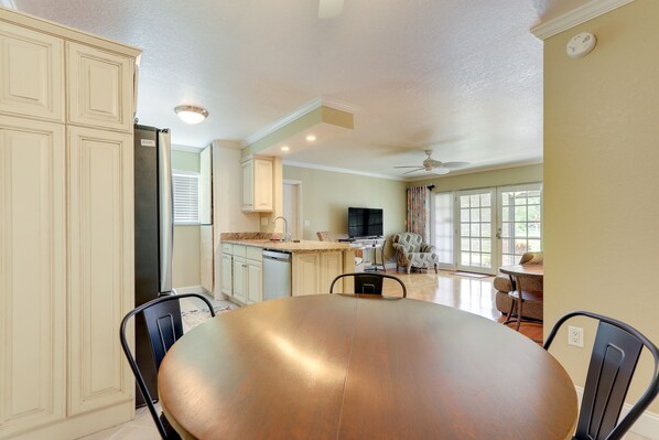 Enjoy meals together at the large dining table surrounded by comfortable chairs.