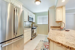 Enjoy cooking in this well-equipped kitchen with a refrigerator, oven, and microwave.