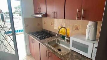 Fridge, microwave, stovetop, cookware/dishes/utensils