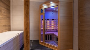 A sauna with a wooden interior and a control panel on the door.