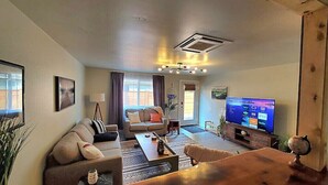 A living room with a sofa, coffee table, and TV.