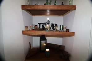 A shelf with various canned goods and a lantern.