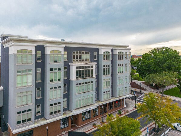 A multi-story building with a modern architectural design, featuring large windows and a flat roof.