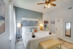A bedroom with a bed, bedside lamps, a ceiling fan, and a bedside table with a lamp. - 'Cloud 9 on the Gulf', 1 Mi to Beach: Pet Friendly (Bay St Louis)