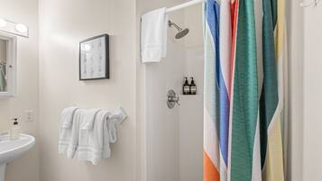 Shower, hair dryer, towels, shampoo