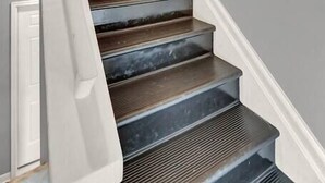 A staircase with a white handrail and dark steps leading to a white door with a brass handle and the number 3 above it.
