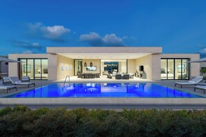 A modern house with a swimming pool, a dining area, and a living room. - Apes Hill Barbados Golf Resort (Orange Hill)