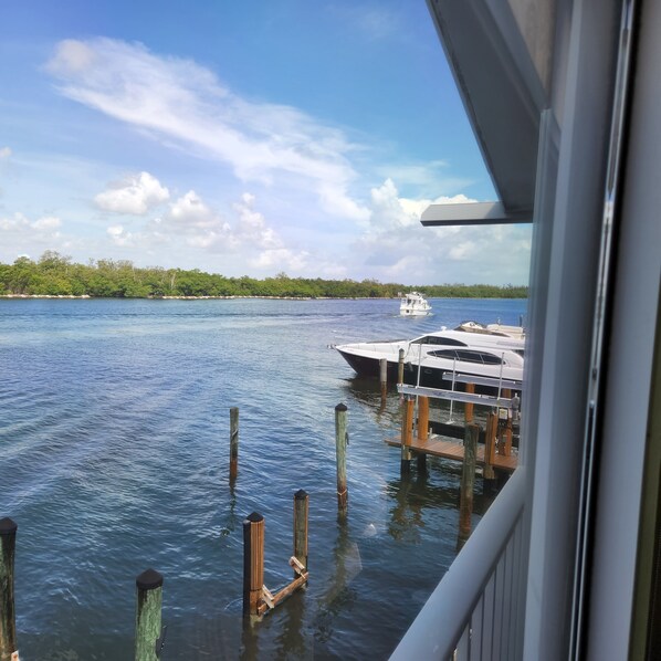 A view of a calm body of water with a dock and a boat.