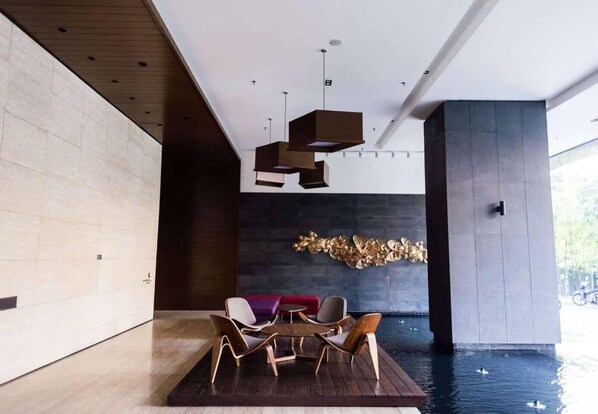 A modern interior with a pool, wooden flooring, and contemporary furniture. - Modern Studio with Stunning City Views (Kuala Lumpur)