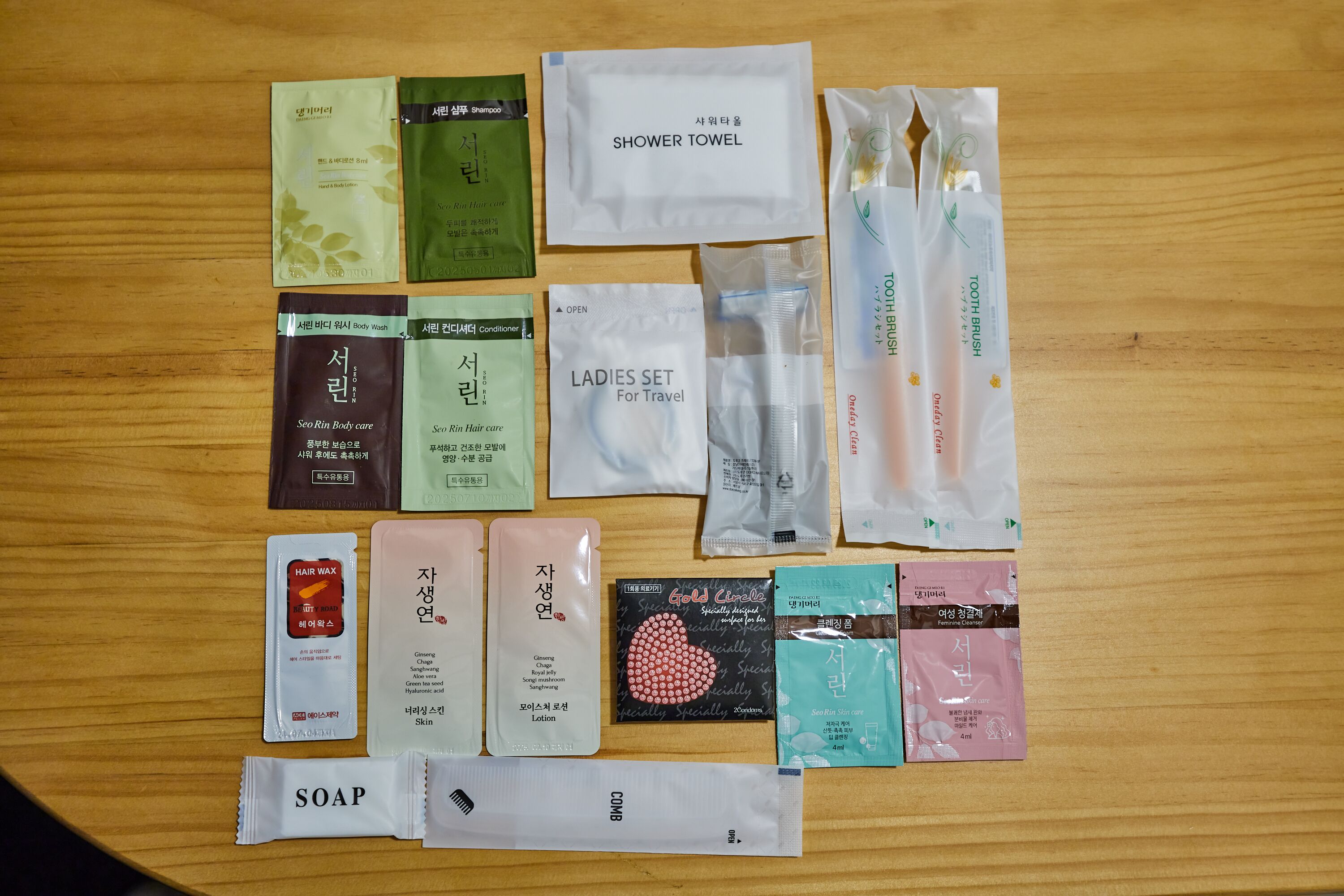 A variety of personal care items arranged on a wooden surface.