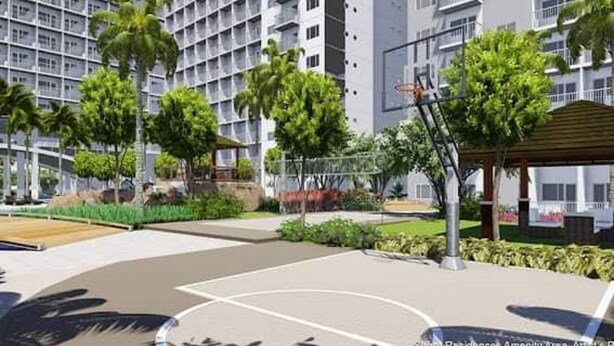 A modern building with a basketball court surrounded by greenery and a covered seating area. - Homefort at Shore 1 Residences (Pasay)