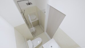 A compact bathroom with a toilet, a shower, and a sink. - Homefort at Shore 1 Residences (Pasay)