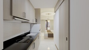 A modern kitchen with a black countertop, stainless steel appliances, and light wood cabinetry. - Homefort at Shore 1 Residences (Pasay)