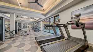 A modern gym with treadmills, stationary bikes, and weight machines. - Boho Soco 1BR Queen Suite w Gympickleballlaundry (Austin)