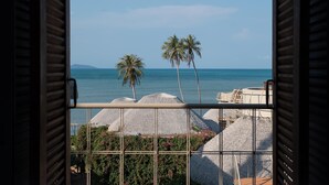 A balcony with a view of the sea, palm trees, and thatched umbrellas. - The Mak Trat (Ko Mak)