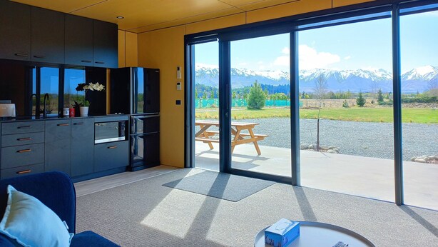 A modern kitchen with a view of mountains.
