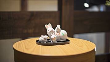 A wooden table with a ceramic rabbit figurine set on top.