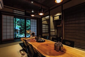 A traditional Japanese room with tatami flooring, a wooden table, and sliding doors. - Mitsuda Kamigyo (Kyoto)