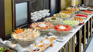 A buffet with various dishes and condiments. - Charming Beauty Hotel (Da Nang)