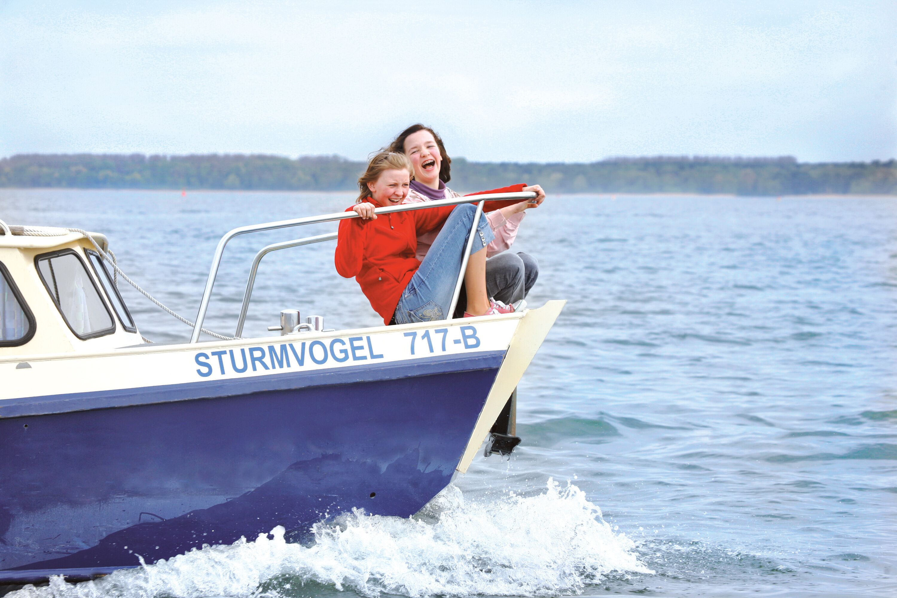 A boat with the name "STURMVOGEL 717-B" on its side, moving through water.
