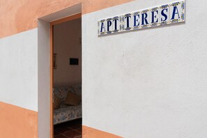 Un letrero con el nombre 'APT TERESA' en una pared blanca.