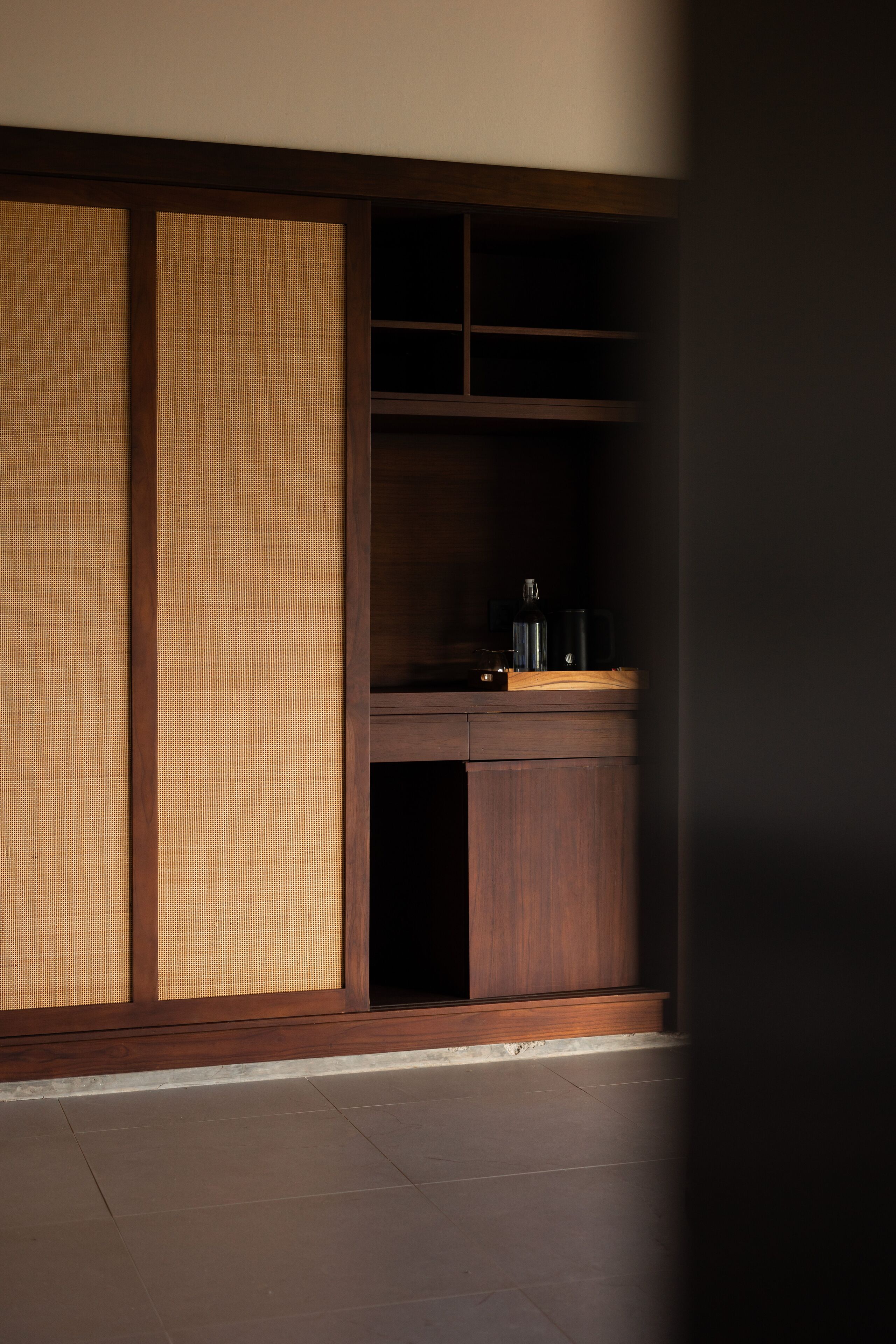 A traditional Japanese room with tatami flooring, a low wooden desk, and a shoji screen.