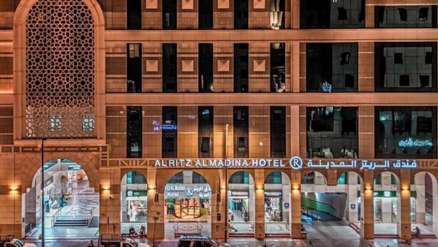 The exterior of Alritz AlMadina Hotel with a prominent arched entrance and multiple floors visible. - ALRITZ ALMADINAH HOTEL - فندق الريتز المدينة (Madinah)
