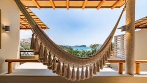 A hammock under a wooden pergola with a view of the ocean and greenery. - Endless Ocean Views and Direct Beach Access (Huatulco)
