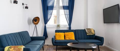 Comfort Apartment | Living room | 37-inch flat-screen TV with satellite channels, streaming services