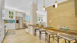 A modern kitchen with a wooden island, white cabinetry, and pendant lighting. - **MODERN MAJESTY @ THE ANNEX** Condo & Pool + Last Key White Glove Service... (Key West)