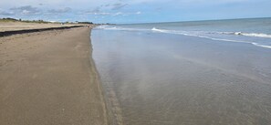 A beach with a wide sandy shore and gentle waves. - Beach-Pickleball-Golf-Tennis-Pools-Fitness Center-Restaurant all in one location (Fort Pierce)