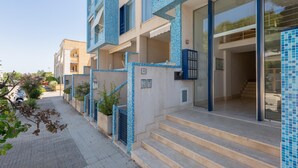 A modern building with a tiled exterior, a staircase leading to the entrance, and a clear sky. - 3500 Panorama D`otranto by Barbarhouse (Otranto)