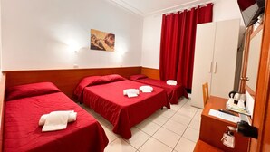 A hotel room with two single beds, a desk with a computer, a TV, and a wardrobe. - Alius And Freerome Hotel  (Rome)