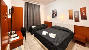 A hotel room with two beds, a desk with a kettle, a wardrobe, and a large window with curtains. - Alius And Freerome Hotel  (Rome)