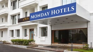 A hotel with a prominent "MONDAY HOTELS" sign, a MoXia Bistro, and a modern entrance with large windows. - Monday Hotels Mahape (Navi Mumbai)