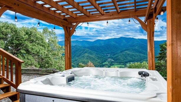 A hot tub under a wooden pergola with a mountain view. - Stunning Mountain Views with Hot Tub & 2 King Suites! Private & Peaceful. (Robbinsville)