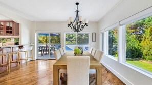 Enjoy meals with family and friends in this dining area, featuring a long table and six matching chairs.