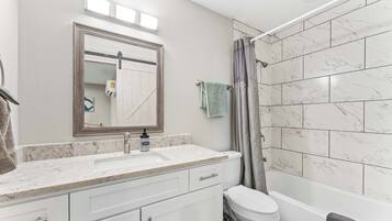 Shower, hair dryer, towels, toilet paper