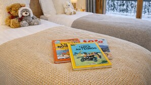 A cozy hotel room with a bed, two pillows, a teddy bear, and a window with a snowy view. - New Ski-In/Ski-Out, 3 Bedrooms with WiFi and Parking (Courchevel 1650)