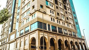 A multi-story hotel with a prominent arched entrance and signage indicating it is an international hotel.