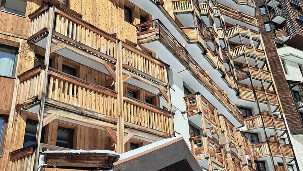 A multi-story building with wooden balconies and a stone facade. - Charming studio for 4 in Avoriaz with balcony (Avoriaz)