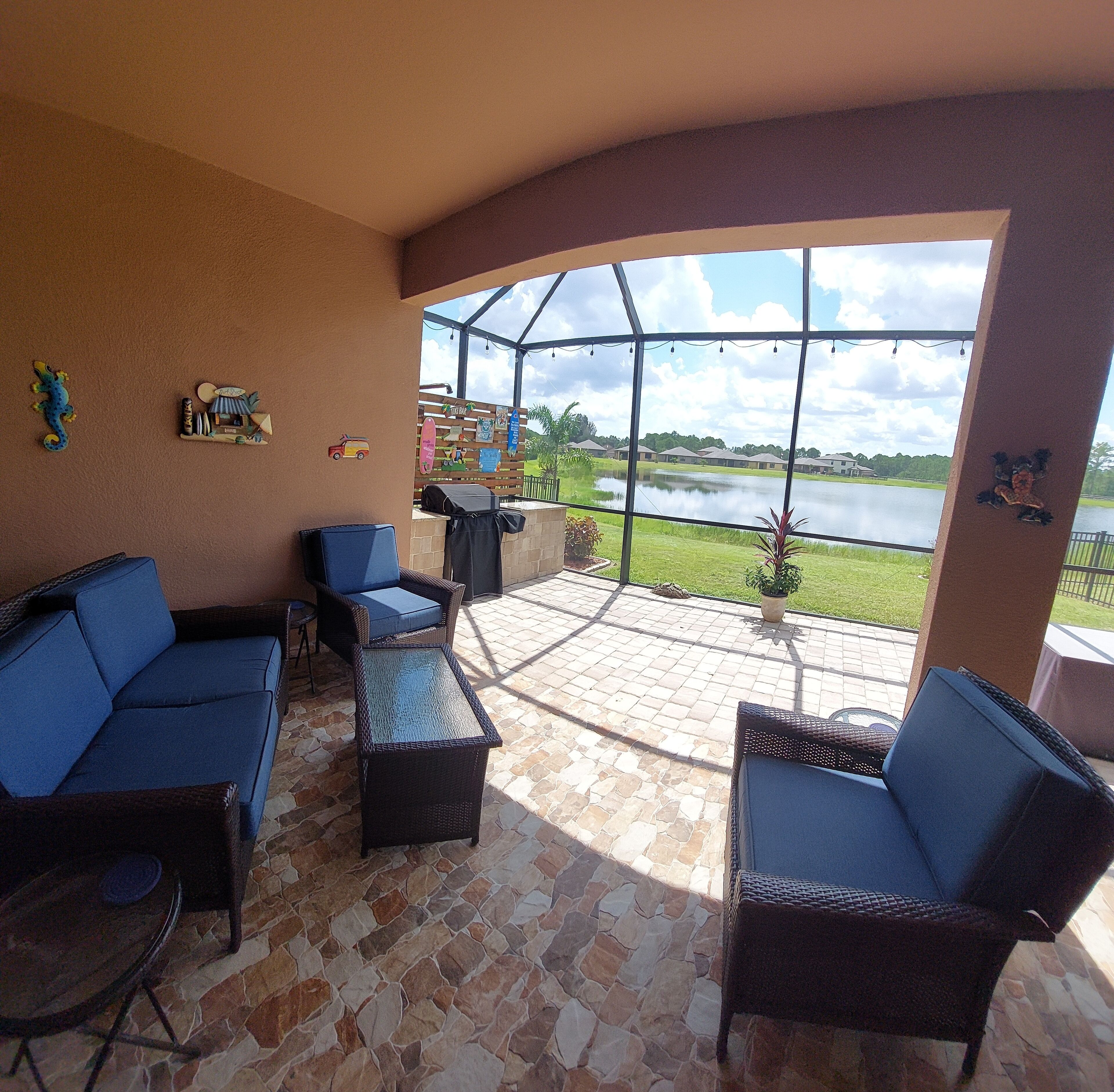 Lake view home with a screened outdoor entertainment area.