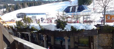 A ski resort with a snow-covered slope, a ski lift, and a building with a sign reading "Les Chevannes."