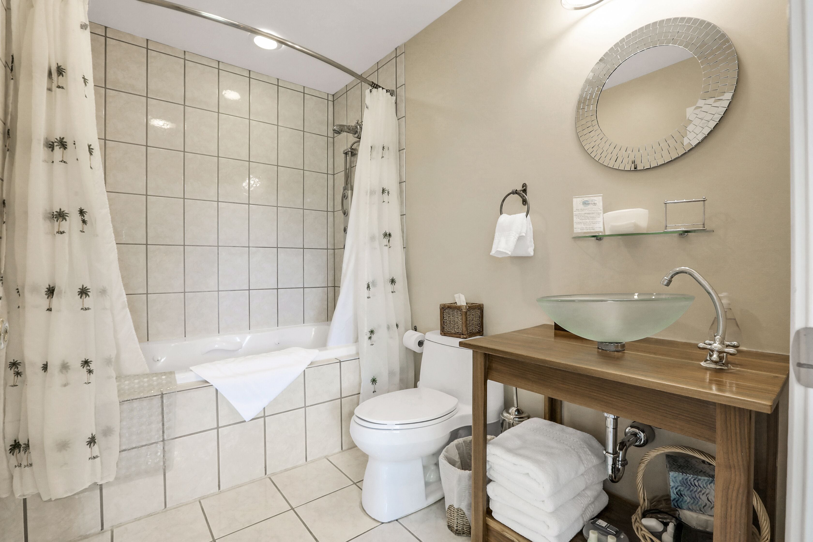 A modern bathroom with a bathtub, toilet, and sink.