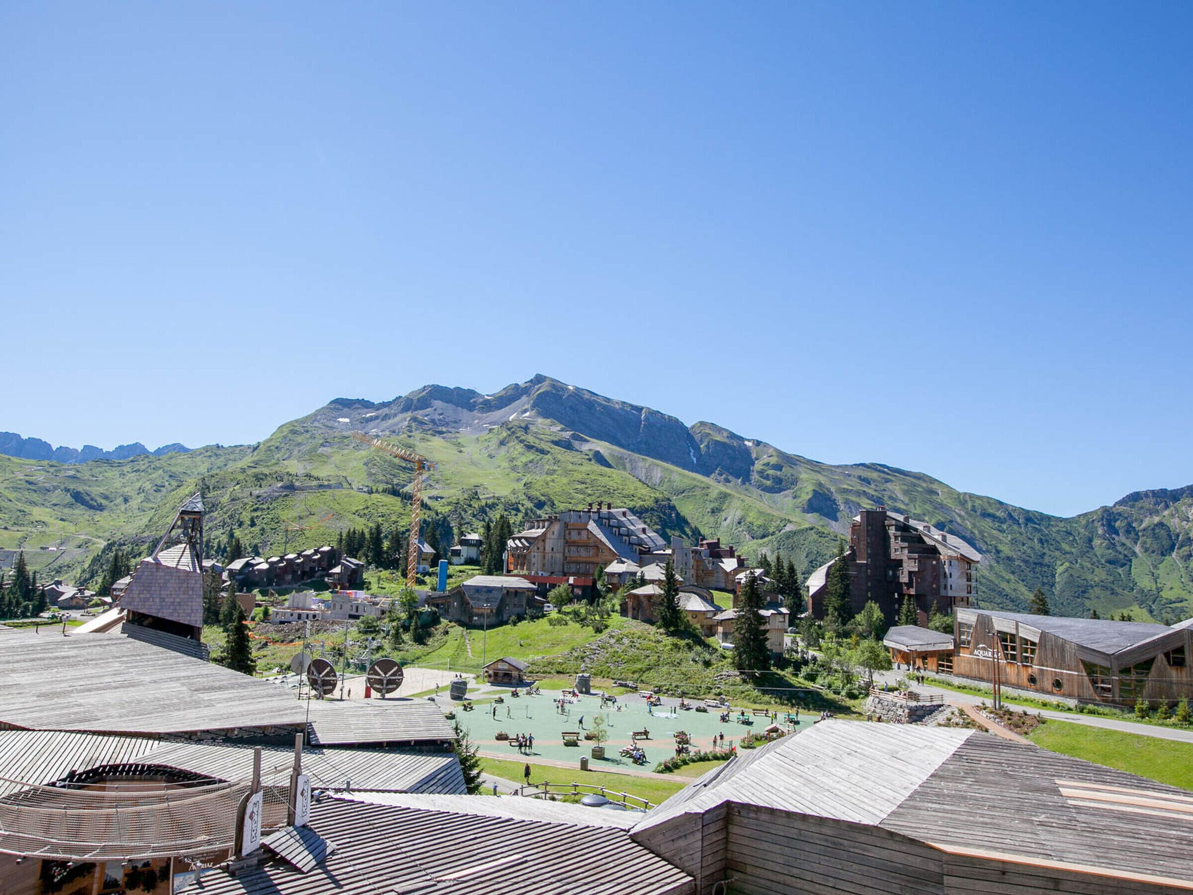 A mountainous town with traditional wooden buildings and a ski area.