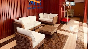 A hotel lobby with a checkered floor, a chandelier, and a sign reading "MII MYAHT'S HOTEL". - Myah's Luxury Suites Hotel (Diamond)