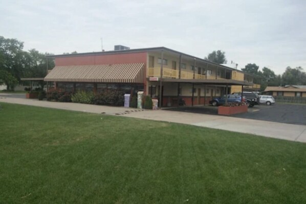 A two-story building with a flat roof and a single-story extension.