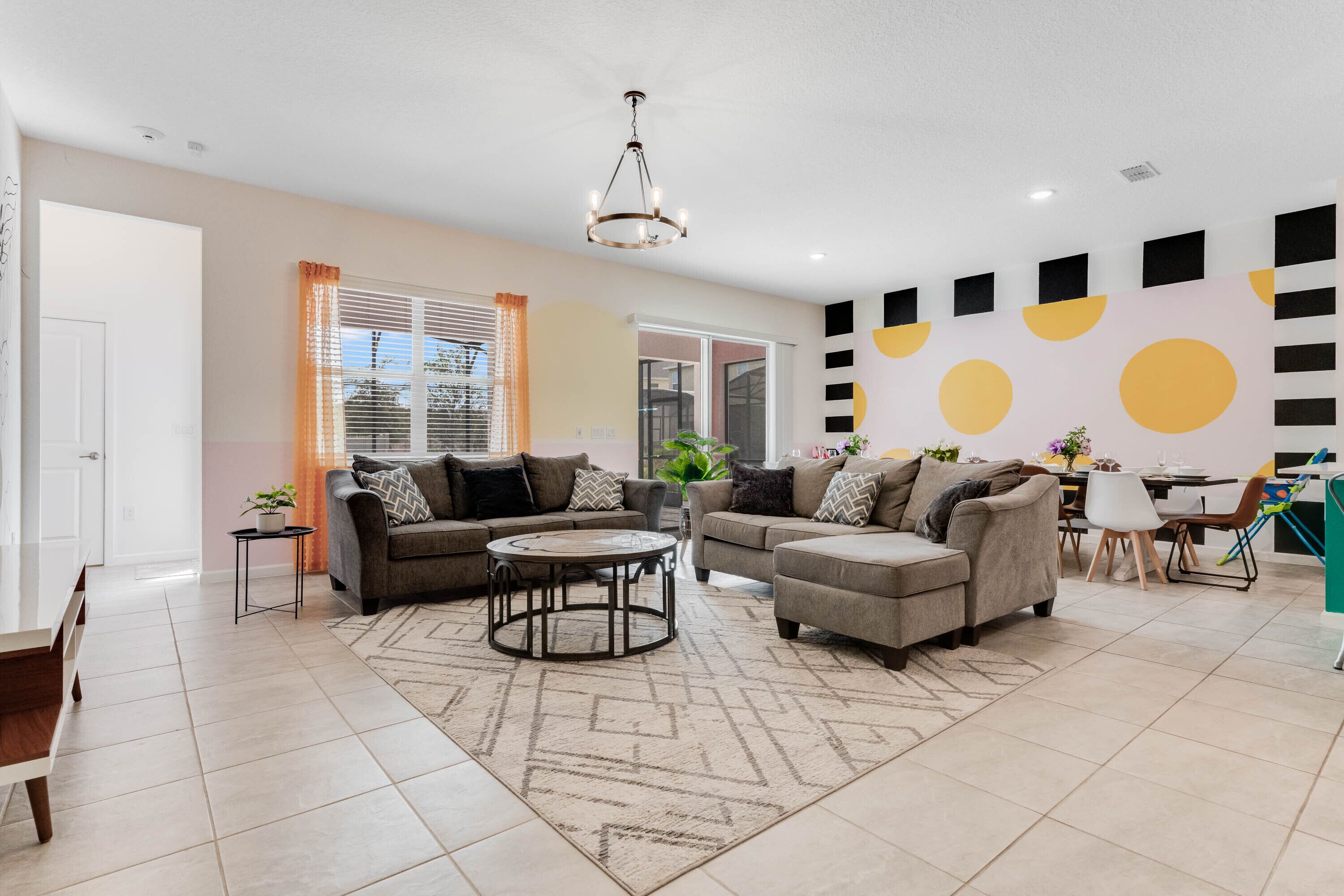 A modern living room with two sofas, a coffee table, and a dining area with chairs.